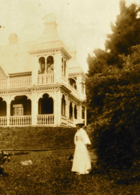 Woman standing on front lawn of Alberton 