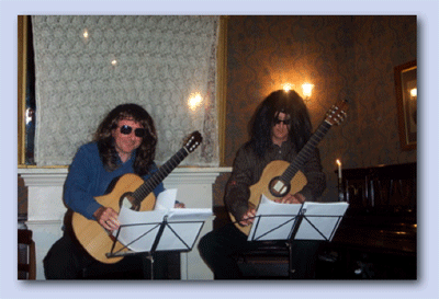 Derek Hasted and Bruce Paine wearing wigs on stage